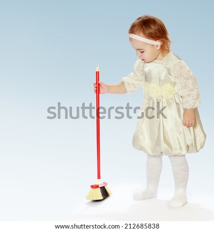 young girl to learn to sweep the floor.The concept of child development, education, recreation