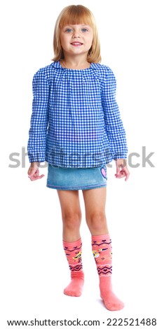 charming little girl in a blue blouse and denim skirt isolated on white background