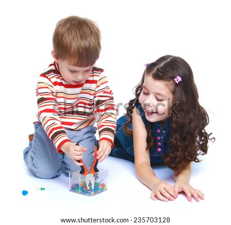 Older sister to look after his younger brother as he plays with a pair of pliers.White background, isolated photo.