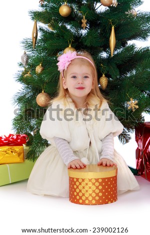 Little girl with a gift in their hands close up. Studio photo, isolated on white background.