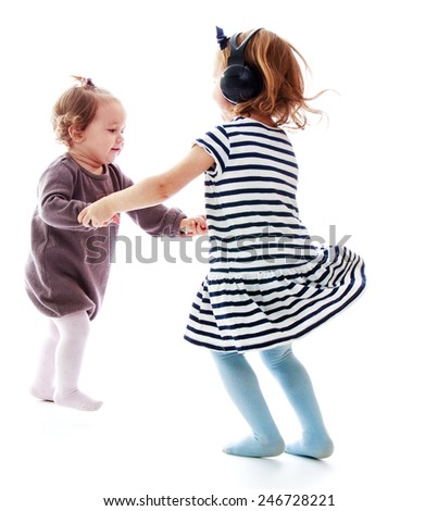 Two girls holding hands sisters dance in a circle.Isolated on white background