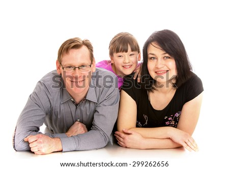 Mom and dad lying on the floor joyful little girl hugs from behind them-Isolated on white background