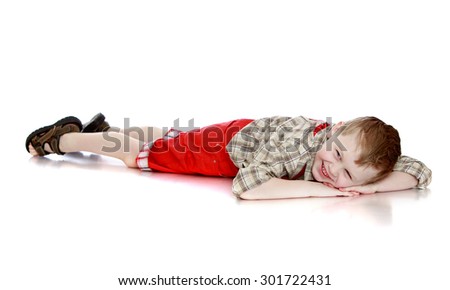 Beautiful little boy with short hair and a denim suit sitting on his lap . Boy happily lifted up his hands-Isolated on white background