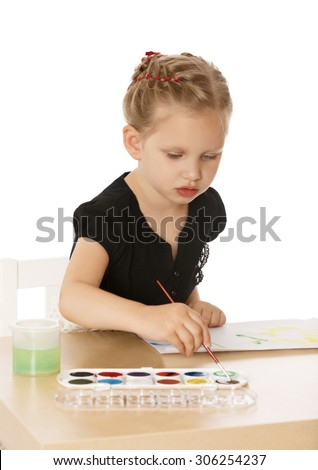 Busy little girl drawing at the table with watercolors. Girl brush smears of dried paint-Isolated on white background