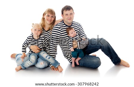 Happy young family dressed in striped shirts. Mom dad little daughter and little son sitting on the floor-Isolated on white background