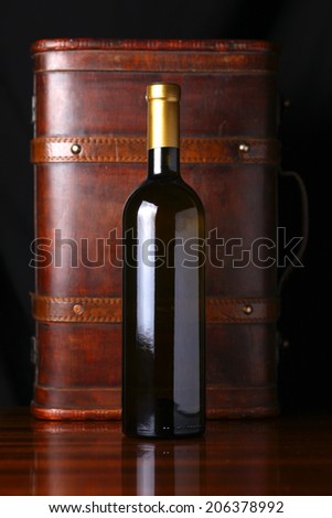 Bottle of white wine with a wooden case in the background