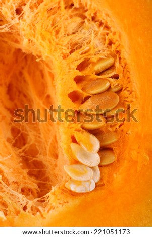 Closeup shot of cut open ripe pumpkin with seeds and pulp