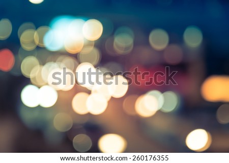 Abstract background of bokeh light at city night with vintage color tone tuned