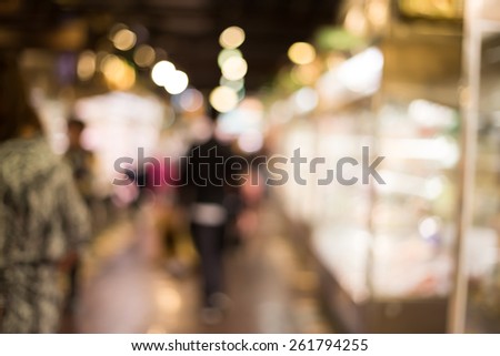 Blurred shopping at supermarket background / color tone tuned