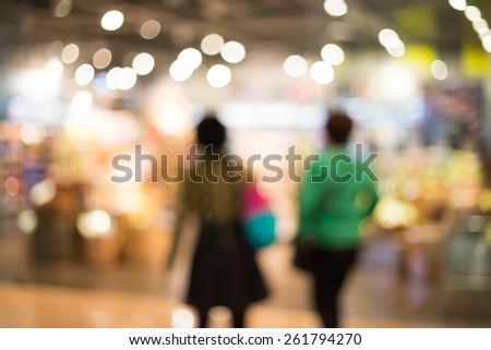 Blurred shopping at supermarket background / color tone tuned