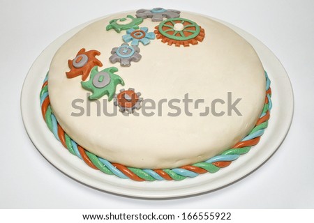 birthday cake with decorations in the shape of toothed wheels