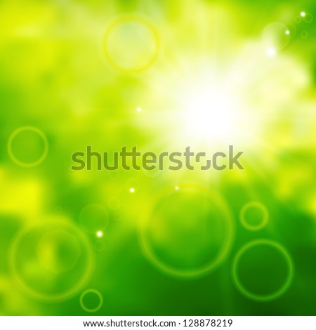 Blurred background of green color with sun beams