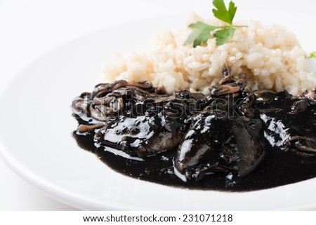 Squid in its own ink with brown rice. Traditional Spanish recipe