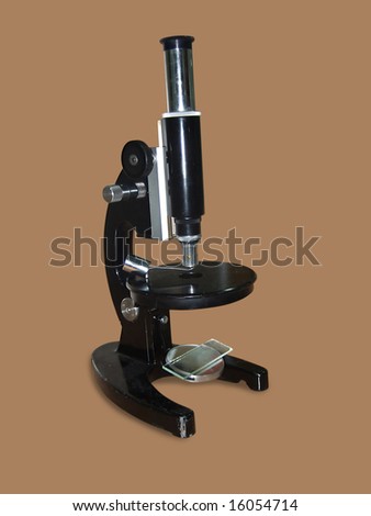 Isolated old style microscope on brown background.