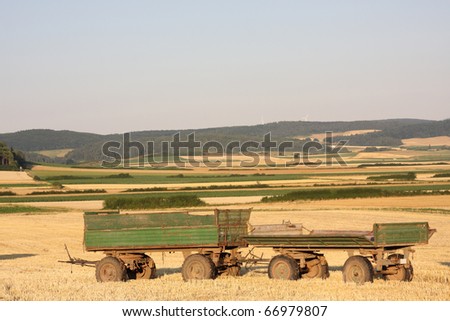 empty trailers on harvested field