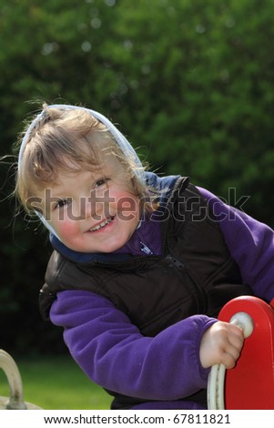playful little girl on a teeter totter
