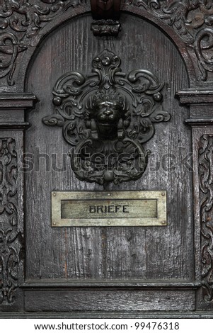 detail of a vintage door with door knocker and letter slot