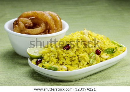 Indian breakfast combination Poha and Jalebi (indian sweets).