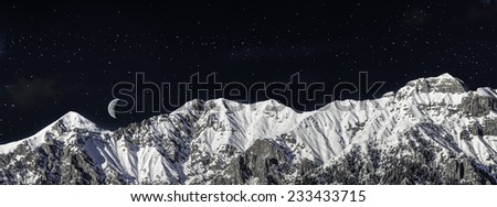 chain of mountains in winter in the night