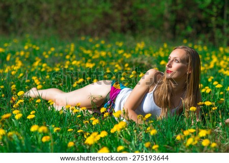 Sensual woman in a flowery meadow
