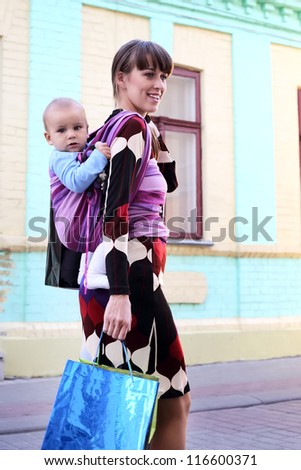young mother with baby in sling