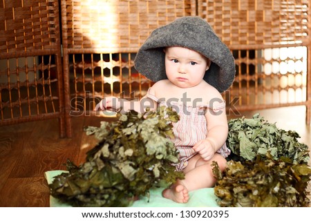 cute little girl with a broom and towel bath cap