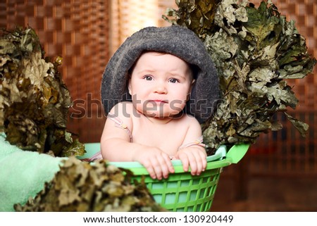 cute little girl with a broom and towel bath cap
