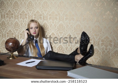 secretary with her feet on the desk