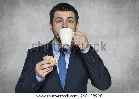 hungry businessman eating a sandwich
