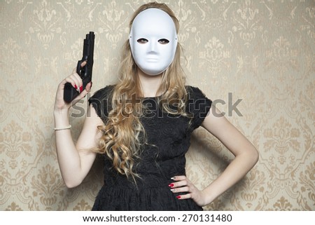 masked woman with a gun in hand