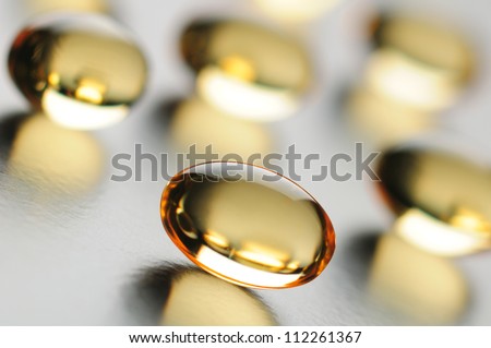 Omega 3 fish oil capsules close up. Differential focus.