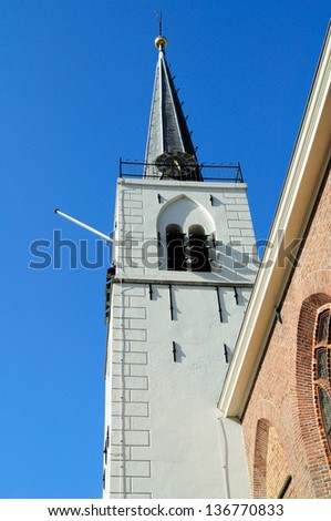 Traditional church tower protected against lightning strike by lightning rod system.