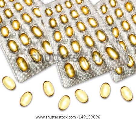 Omega 3 fish oil capsules close up in modern strip packaging with loose capsules on white foreground.