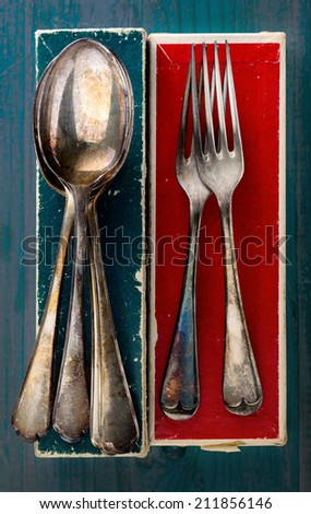 Retro table silver. Silver metal tarnished forks and spoons on their boxes as found at flea market.