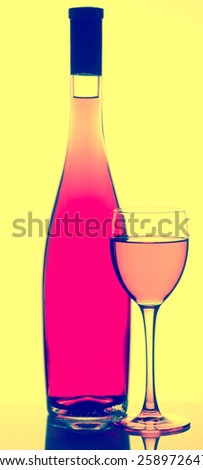 Wine bottle and glass. Rose wine in bottle and glass with filter effects.