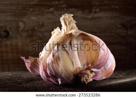 Garlic bulb on rustic wooden background. Detail and structure of garlic bulb.