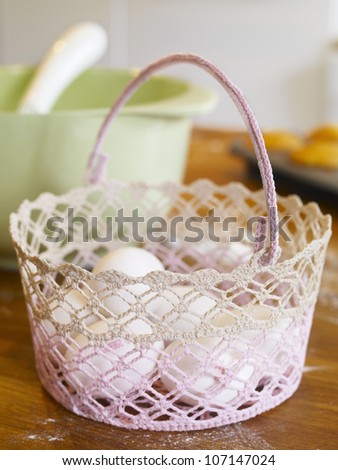 White eggs in knitted basket