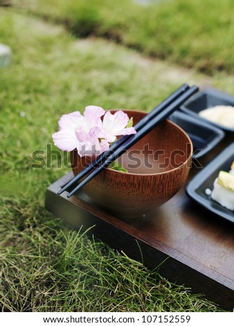 Grass on a table set with sushi.