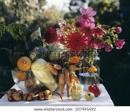 Containers filled with fruits and flowers lying on table
