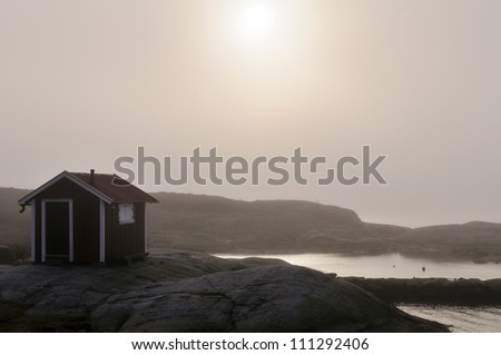 Boathouse in the fog by the sea, Sweden