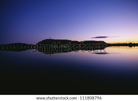 View of a mine reflecting in water in dusk