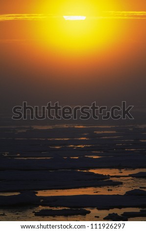 The midnight sun above the melting ice of the Arctic, Canada
