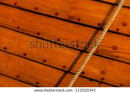 Traditional klink-built wooden boat hull and rope