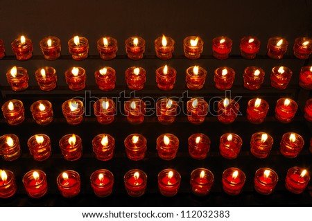 Rows of tealight candles in church, elevated view
