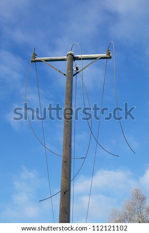 Old utility pole with broken cables