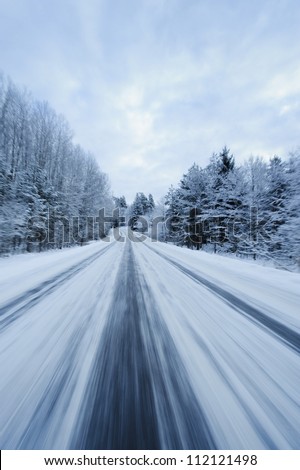 Snow covered country road from below in motion blur