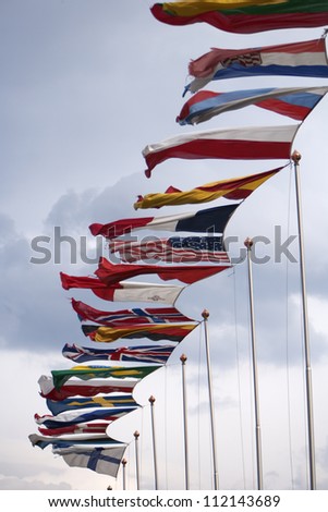 Row of national flags blowing in wind
