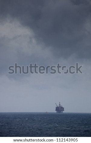 Distant view of oil rig on sea