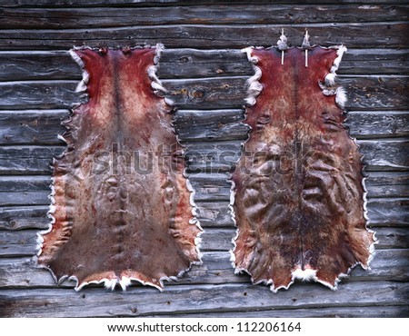 Two animal hides on wooden table