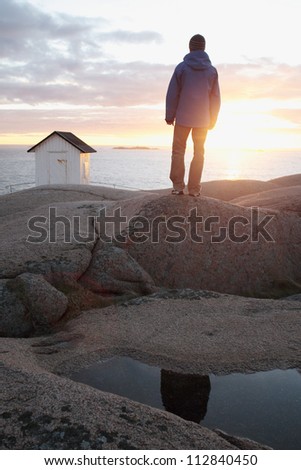 A man watching the sun go down, Bohuslan, Sweden.